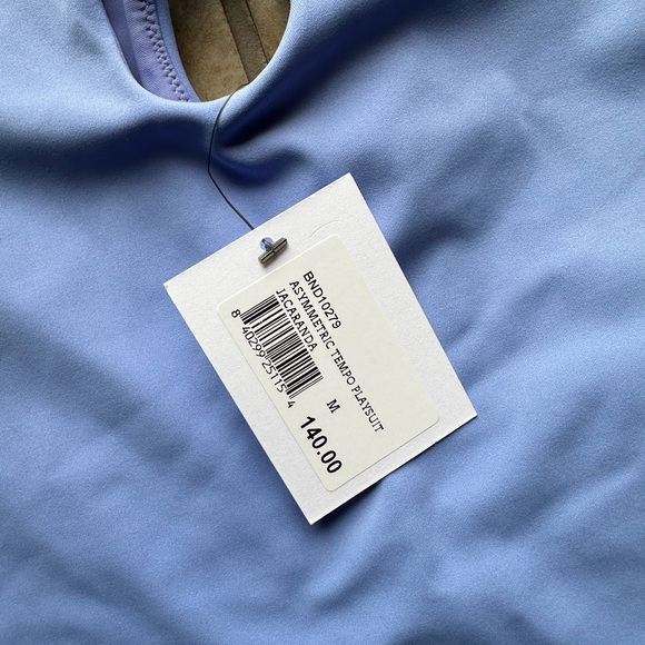 Bandier Asymmetric Tempo Short Catsuit in color Jacaranda Periwinkle - Picture 6 of 6